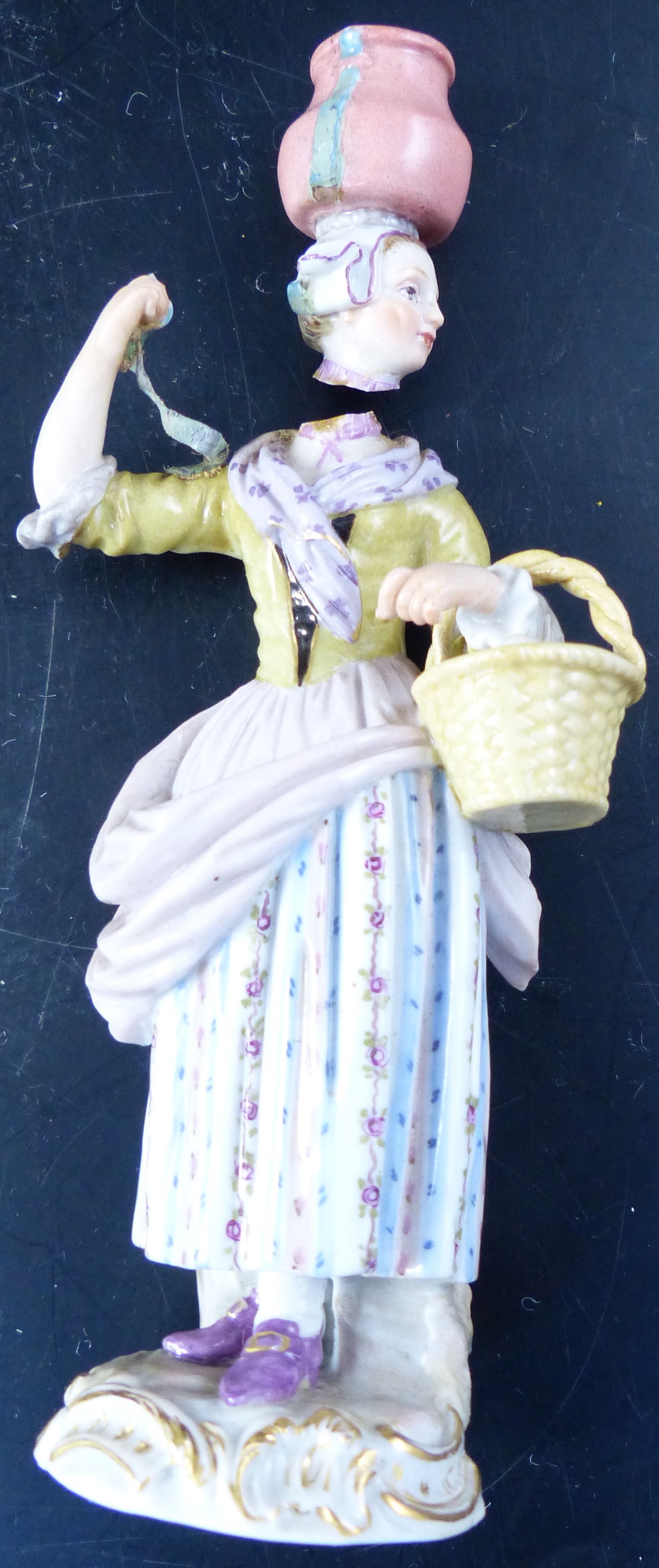 A pair of early 20th century Meissen figures of street vendors, 14cm (a.f.)